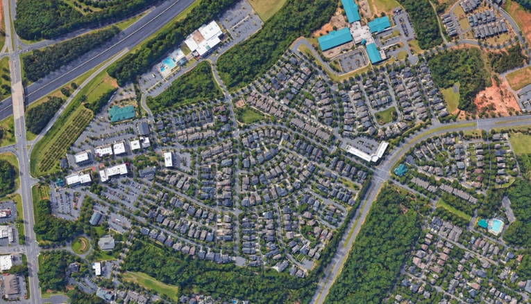 Aerial map of Baxter Town Center location at 951 Market Street in Fort Mill, showing nearby neighborhoods, roads, parking areas, shops, and green spaces.
